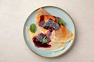 Portion of sweet crepe blini pancakes with jam