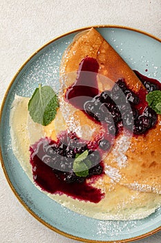 Portion of sweet crepe blini pancakes with jam