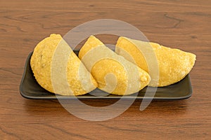 Portion with three Colombian corn flour empanadas