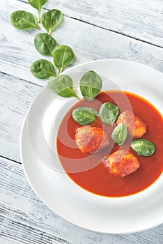 Portion of tomato soup with meatballs