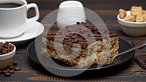 Portion of Traditional Italian Tiramisu dessert, cup of espresso, milk , brown sugar and coffee