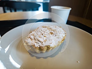 A portion of vanilla tart and coffee in a cafe