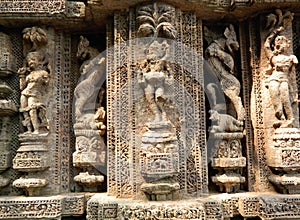 A portion of a wall decorated with various idols curved out of stones of Konark Sun Temple, Odisha, India