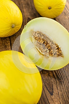 Portion of Yellow Honeydew Melon on wooden background selective