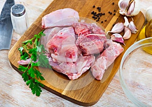 Portioned rabbit legs and saddle with herbs and spices