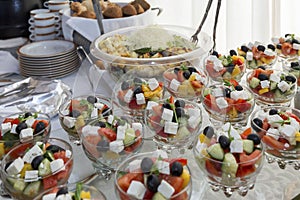 Portioned salads in glass bowls on the buffet table. Business meetings and holidays