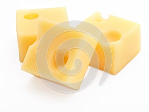 Portions cubes, dice of Emmental Swiss cheese. Texture of holes and alveoli. Isolated on white background