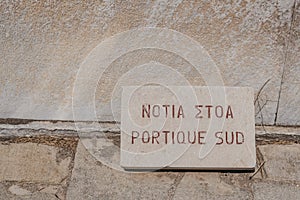 Close up of the Portique Sud `Portico of the South` sign on the island of Delos, Greece