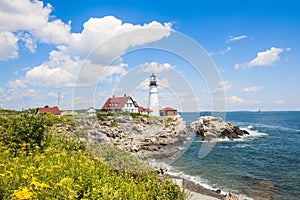 Portland Head Lighthouse in Maine, blooming flowers in front of lighthouse, USA