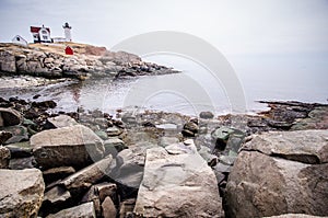 Portland Head Lighthouse in Portland Maine with rocky shoreline