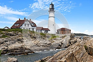 Portland lighthouse with a house by the sea at Fort Williams Park photo