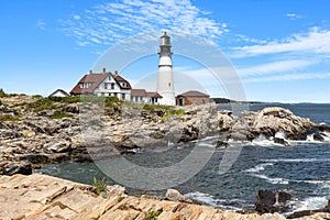 Portland lighthouse with a house by the sea at Fort Williams Park photo