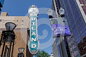 Blue Portland sign on brick building from distance in Portland, Oregon