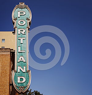 Portland sign from 30's on brick building in Portland, Oregon, USA with clear blue sky
