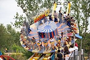 Kids and adults riding amusement park ride