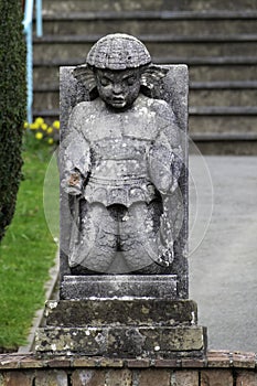 PORTMEIRION, UNITED KINGDOM - Feb 22, 2019: A weathered sculpture in Portmeirion