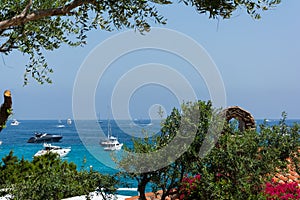 Panoramic view of small pevero beach with yacht