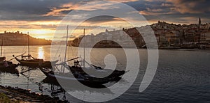 Porto cityscape in sunset with river on the front and wine carrier ship in  foreground and city of Porto in background, Portugal