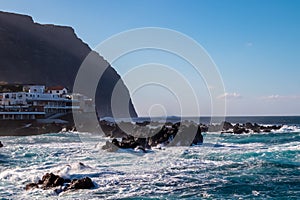 Porto Moniz - Strong waves smashing against jagged volcanic rocks on coastline of coastal town Porto Moniz, Madeira island