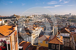 Porto panoramic landmark with boats river Douro. Old buildings with brick roofs by river Douro in Porto, Portugal.