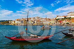 Porto, Portugal, colorful houses of Riberia district and the Douro River with traditional Rabelo boats with wine barrels