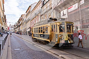 Porto, Portugal - October 06, 2018: Vintage wooden tram in city centre Porto. Traditional trams rattle through the narrow streets