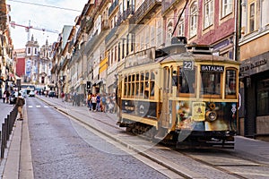 Porto, Portugal - October 06, 2018: Vintage wooden tram in city centre Porto. Traditional trams rattle through the narrow streets