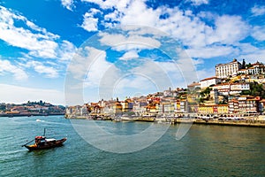 Porto, Portugal old town cityscape and the Douro River with traditional Rabelo boats