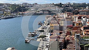 Porto, Portugal old town ribeira aerial promenade view with colorful houses, Douro river and boats