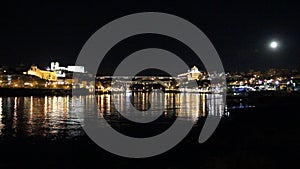 Porto, Portugal: Panoramic night view of the historic cityand famous Dom Luiz bridge, and their reflections over Douro river
