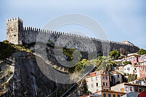 Porto, Portugal`s midieval city walls make an imposing site from the waterfront below.