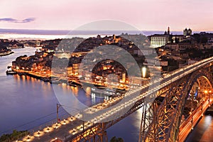 Porto skyline and Douro River at dusk with Dom Luis I Bridge on the foreground