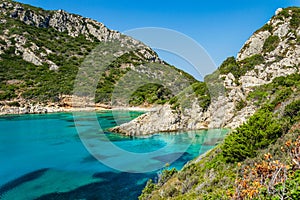 Porto Timoni beach on Corfu island in Greece. Beautiful view of green mountains, clear sea water, secluded Pirates bay