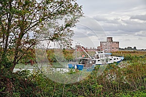 Porto Tolle, Veneto, Italy: view of the Po Delta Park with a fishing boat in the river