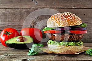 Portobello mushroom vegan burger against a dark wood background