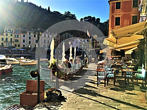 Portofino Italian village in Liguria region, Italy. Boats, seaside, water, tourism and restaurant