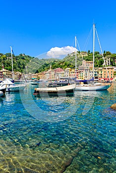 Portofino, Italy - Harbor town with colorful houses and yacht in little bay. Liguria, Genoa province, Italy. Italian fishing