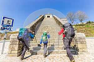 Portomarin, Spain - Two Adults and Child Pilgrims Ascending Stairs at City Entrance to Portomarin, along the Way of St James
