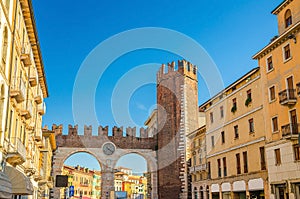 Portoni della Bra gate with merlons and clock, old Roman city double brick gate