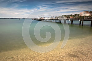 Portoroz, Slovenia - May 26, 2019 - people relaxing on wooden footbridge pier in Portoroz on adriatic coastline