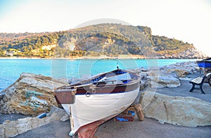 Portovenere, Italy  View on Palmaria island from Portovenere beach with old  wooden boat . Liguria