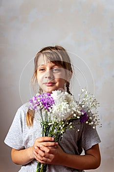 Portrait of 10 years old  girl  with a bouquet of flowers