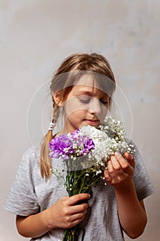 Portrait of 10 years old  girl  with a bouquet of flowers