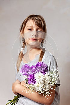 Portrait of 10 years old  girl  with a bouquet of flowers