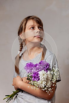 Portrait of 10 years old  girl  with a bouquet of flowers