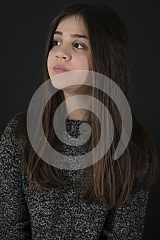 Portrait of 12 Y old little girl on black background