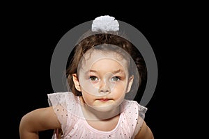 Portrait of 3 year old little girl on black background