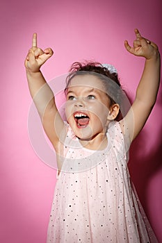 Portrait of 3 year old little girl on black background