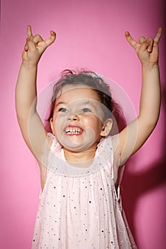 Portrait of 3 year old little girl on black background