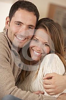 Portrait 30s couple hugging indoors